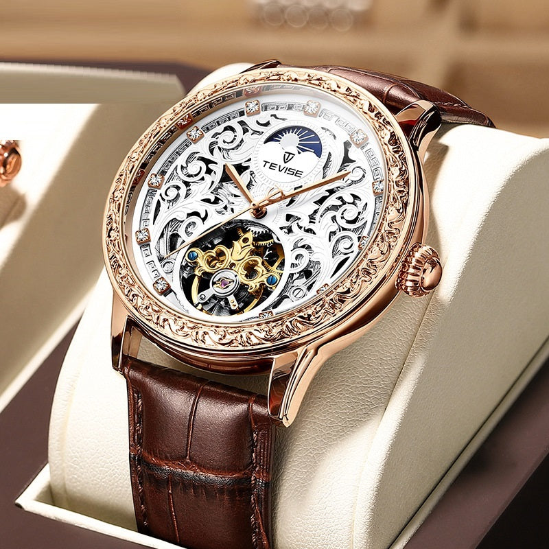 Rose-gold mechanical skeleton watch with brown leather strap and ornate openwork dial