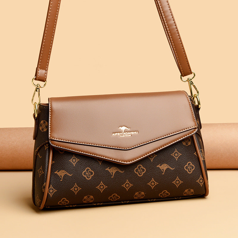 Dark brown patterned crossbody shoulder bag with taupe flap and gold-tone chain strap