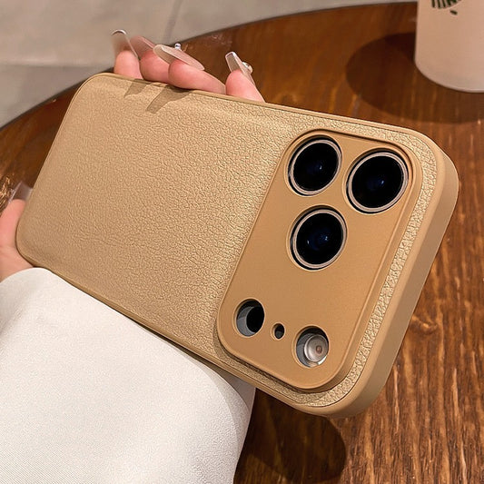 Gold phone case held by a person on a wooden surface