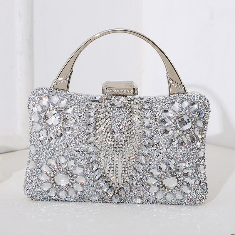 Handmade diamond clutch bag in silver with crystal floral border and gold-tone handle
