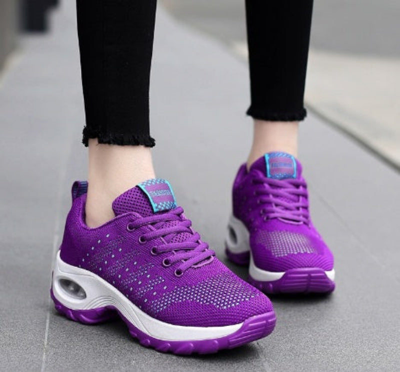 Purple knit walking sneakers with teal lace tabs and white/pink air-cushion sole