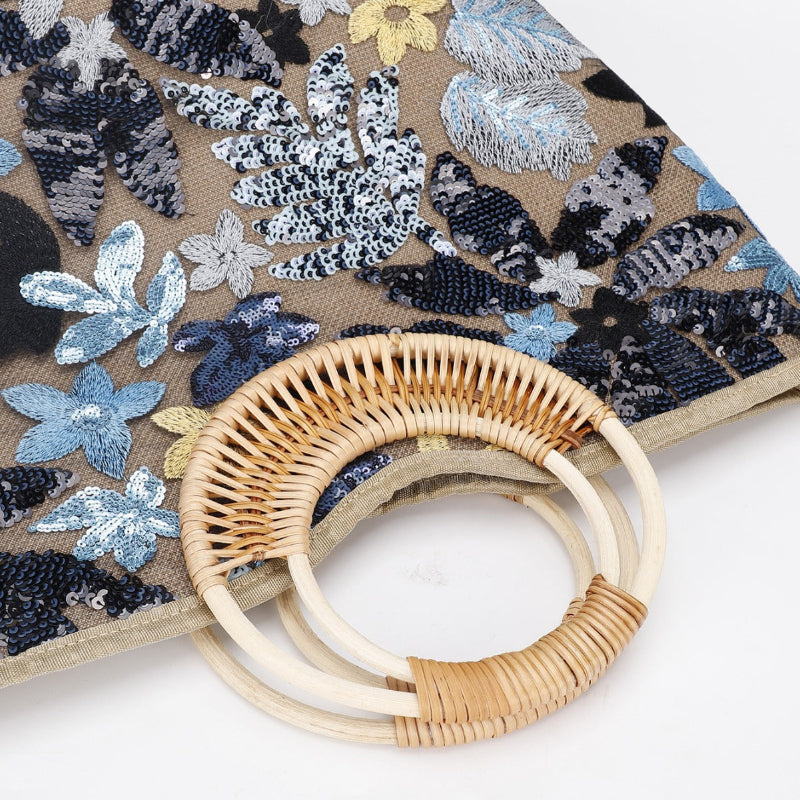 Rattan half-moon handle on large woven cotton tote with blue and silver sequined florals
