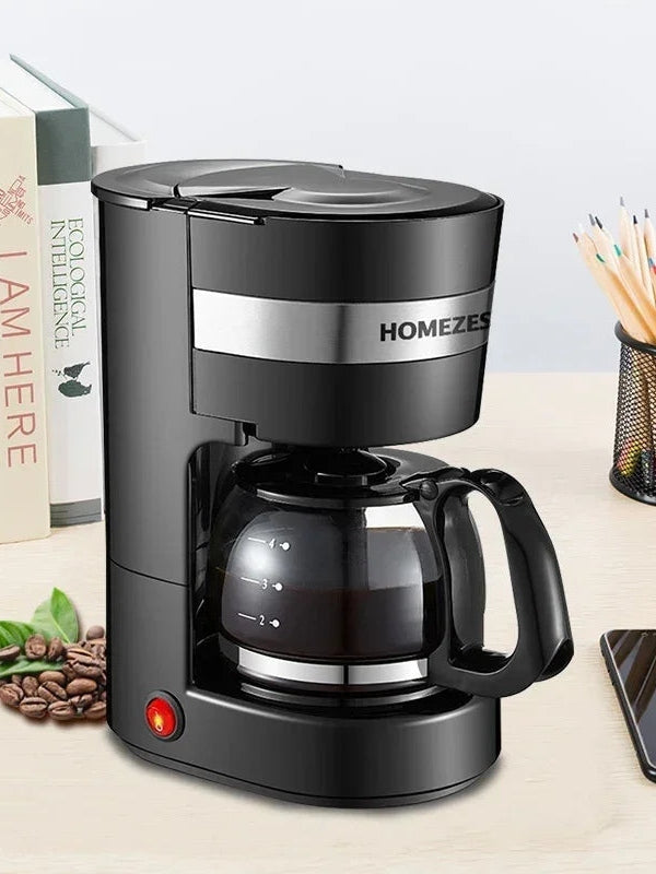 Black automatic drip coffee maker with glass carafe and front handle