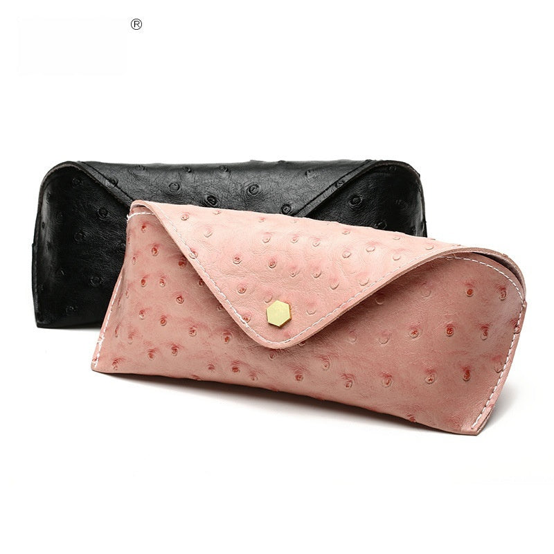 Pink polka dot leather sunglasses case with curved flap and gold-tone clasp