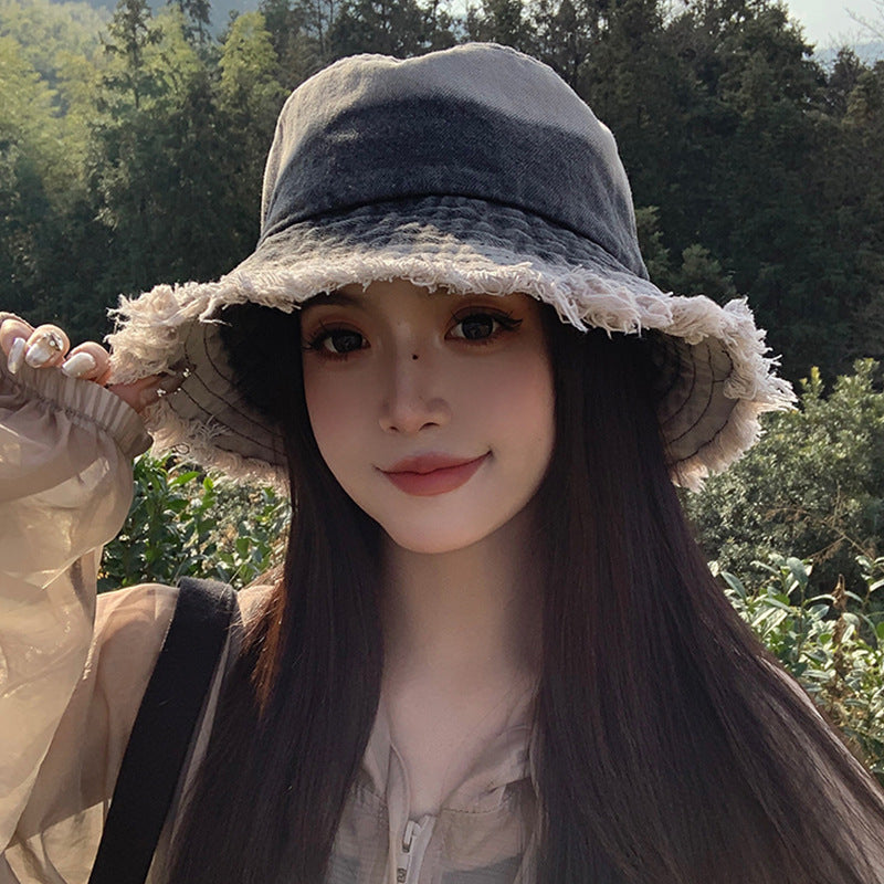 Black denim bucket hat with frayed wide brim and stitched crown