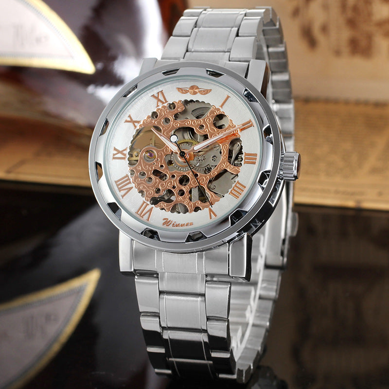 Mechanical skeleton watch with orange dial accents, exposed gears, and silver bracelet