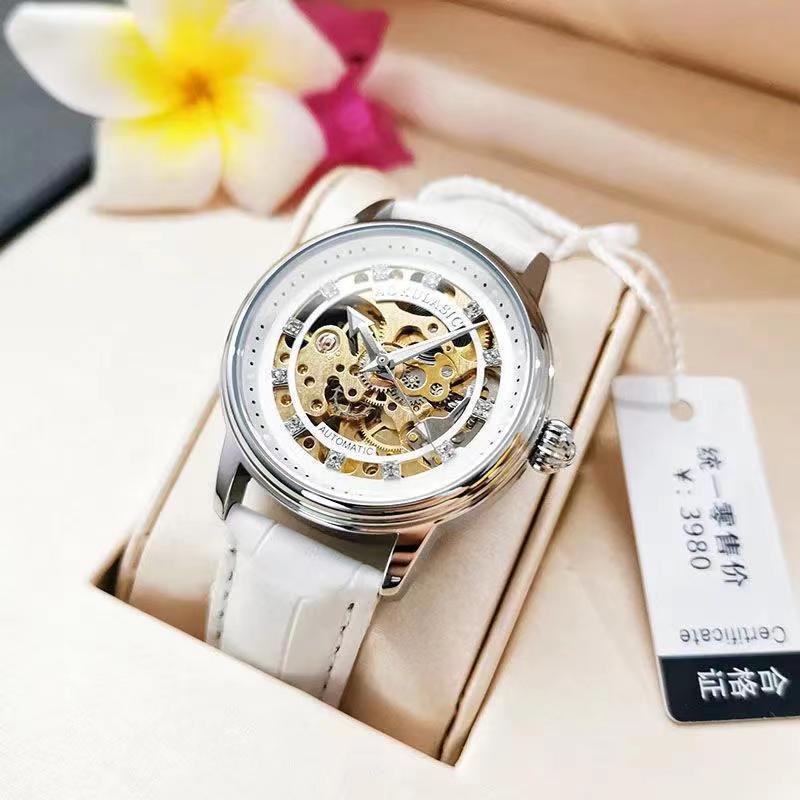 White leather-strap mechanical watch with rose-gold case and diamond-accent bezel