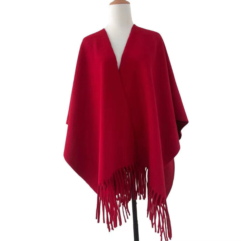 Deep red tassel-fringe travel cape with draped front and open neckline
