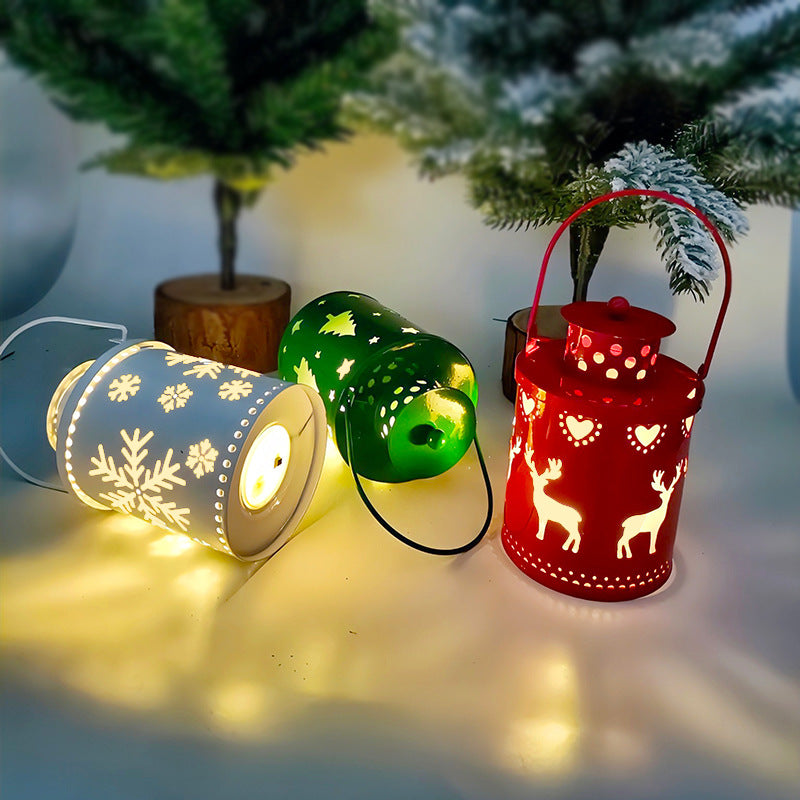 White, green, and red LED lantern candles with snowflake and reindeer cutouts