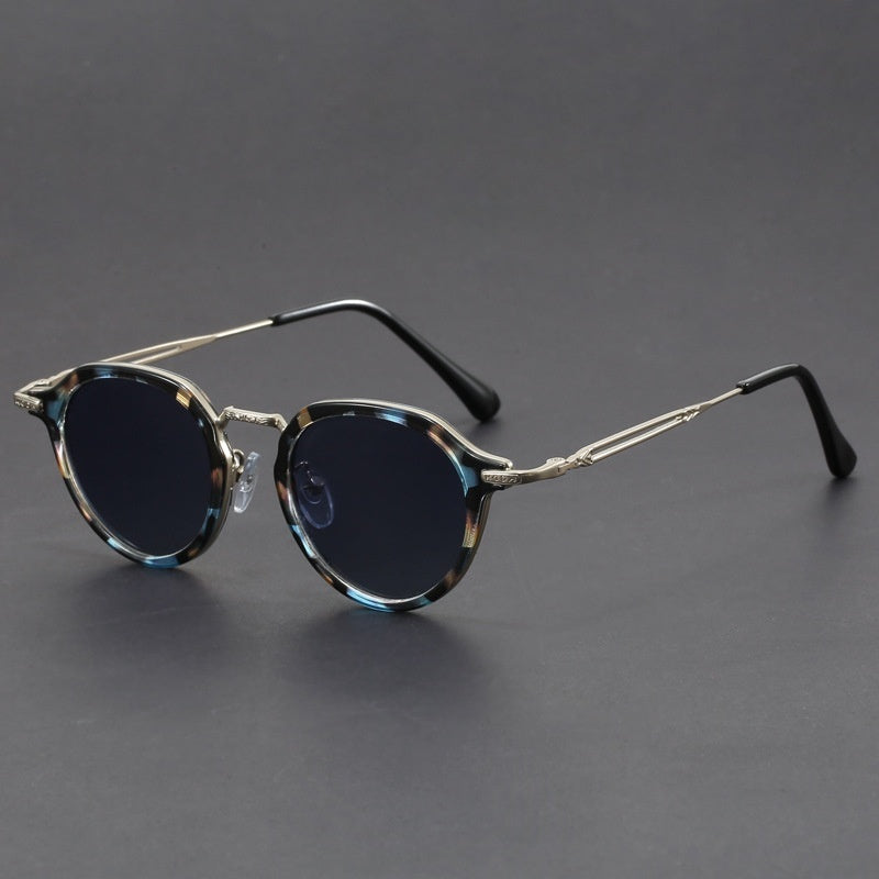 Unisex round metal sunglasses with dark lenses and blue-tinted temple details