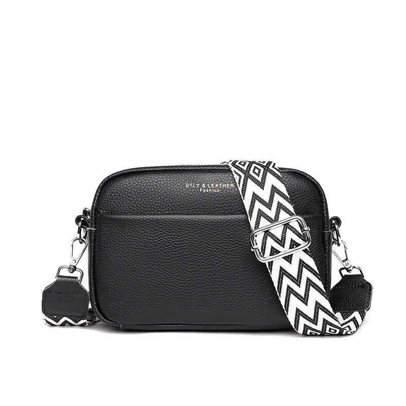 Black faux leather crossbody bag with chevron strap and silver-tone buckle clasp