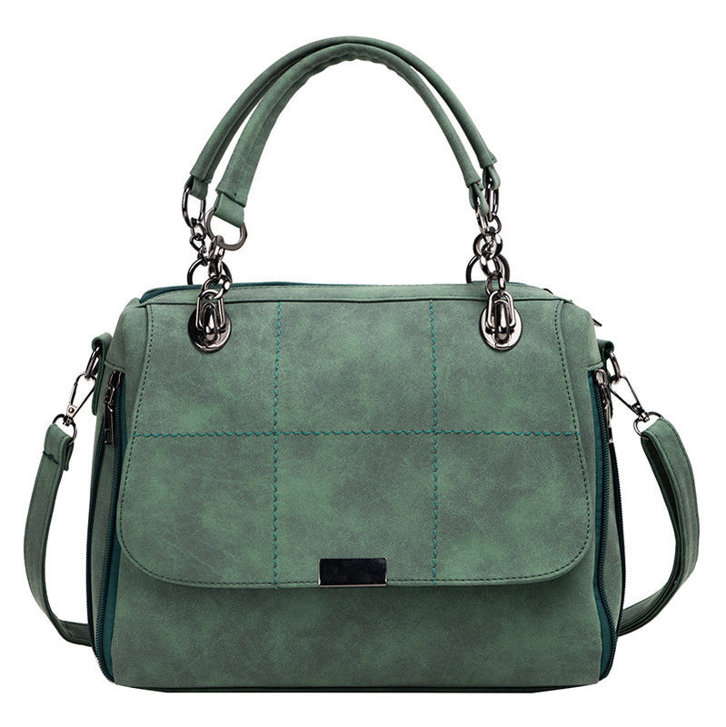 Large matte shoulder bag in green with front flap, metal ring handles, side zipper pockets
