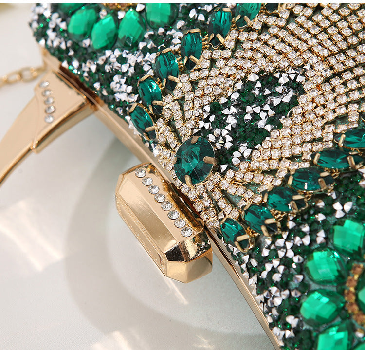 Close-up diamond clutch detail with green crystal flowers and gold rhinestone tassel