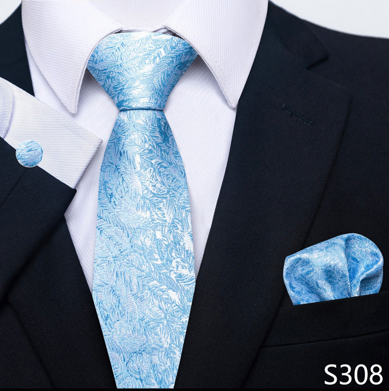 Light blue patterned tie set with matching pocket square and round cuff links.