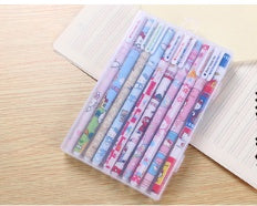 Set of colorful stationery items in a transparent case on a wooden surface