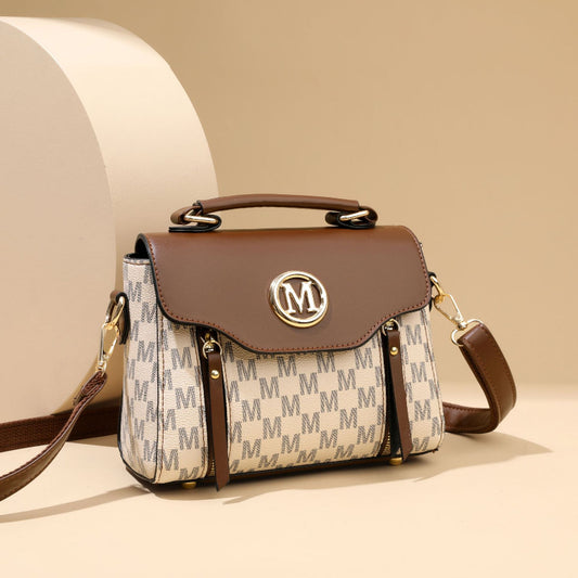 Designer handbag with brand logo on a beige background