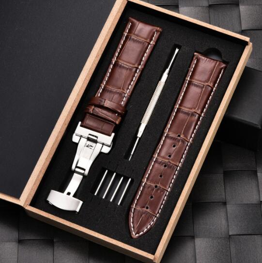 Brown leather strap bracelet with silver butterfly buckle, laid in gift box