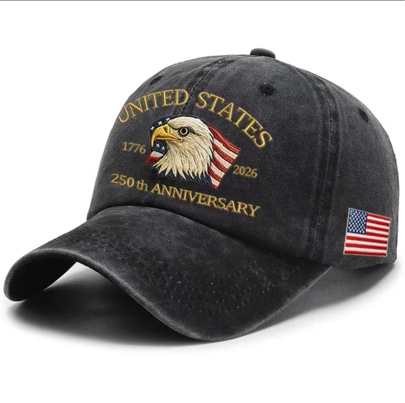 Charcoal gray washed-print cap with gold “United States 1776–2026” eagle graphic and flag patch.