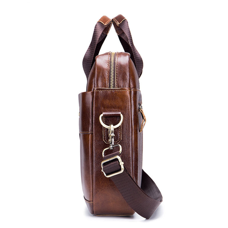 Brown leather briefcase side view with metal buckles and adjustable crossbody strap