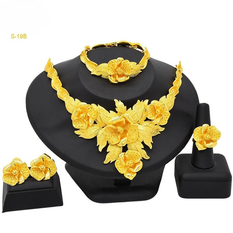 Gold-plated floral choker set with necklace, bracelet, stud earrings, and ring