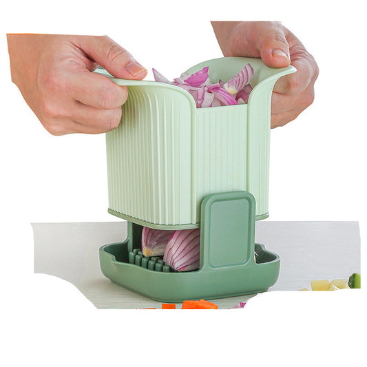 Person using a green onion chopper to slice an onion on a white background