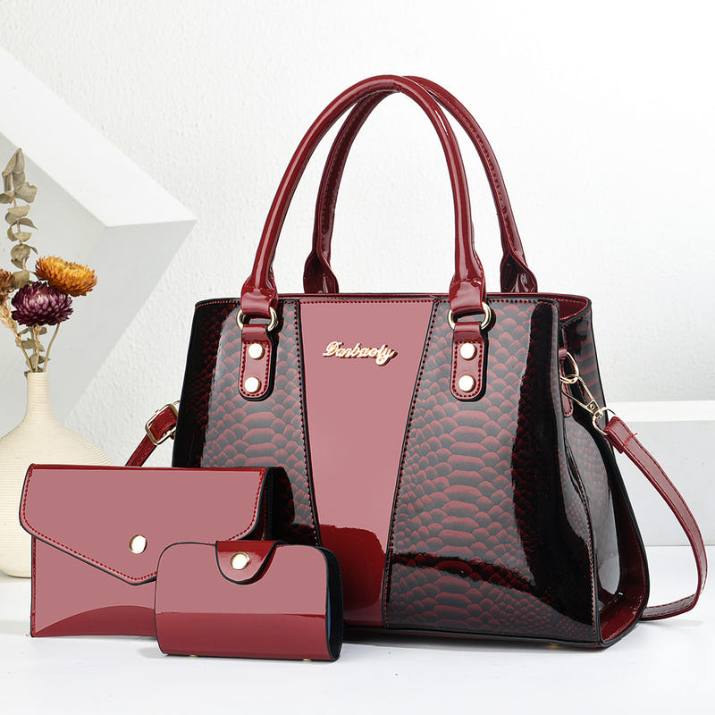 Red shoulder tote bag with side crossbody strap, scalloped texture, front pocket, and wallet