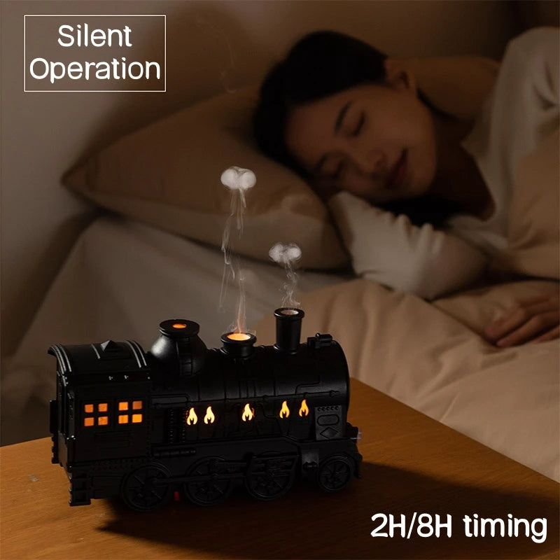 Black train aromatherapy humidifier diffuser with warm LED glow and visible mist