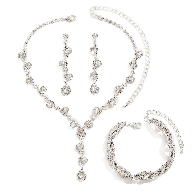 Crystal jewelry set with rhinestone necklace, dangling ear studs, and hoop bracelet; silver-tone.