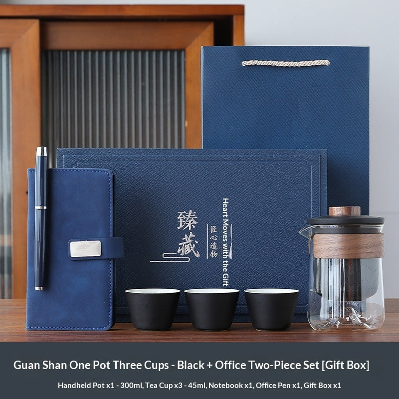 Black office gift set with dark notebook and pen, black cups, and tea pot tumbler