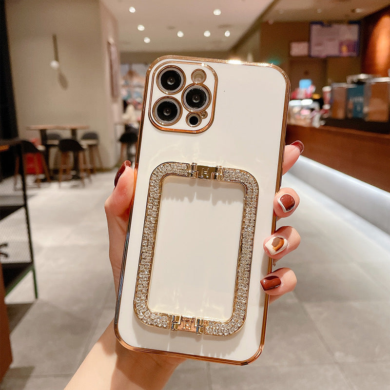 Phone case with decorative frame held by a person in an indoor setting