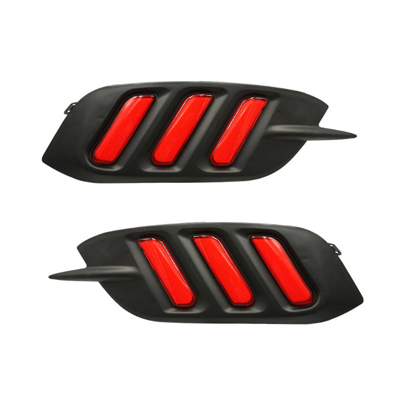 Pair of rear bumper signal lights with red lens bars in black housings