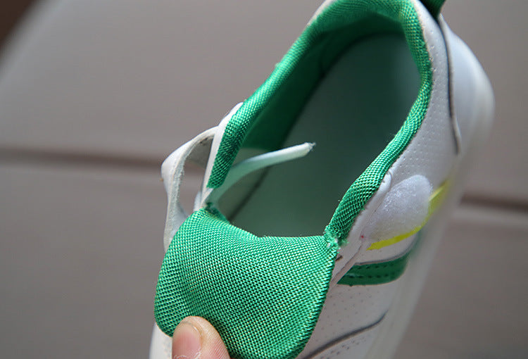 Kids white sneaker showing green fabric collar and cushioned interior