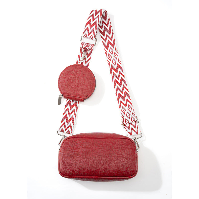 Red faux-leather crossbody bag with adjustable strap, front pocket, round mini pouch
