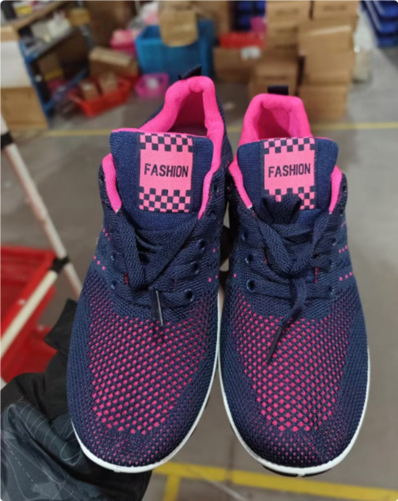 Navy knit walking sneakers with pink speckled pattern and checker patch detail