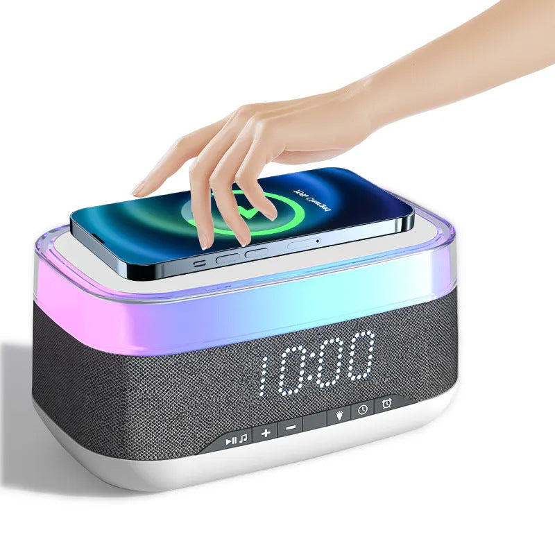 White and gray smart alarm clock Bluetooth speaker with hand resting on glowing top