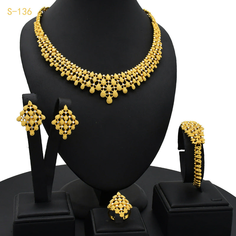 Gold-plated chain necklace set with matching earrings, ring, and stacked bangle
