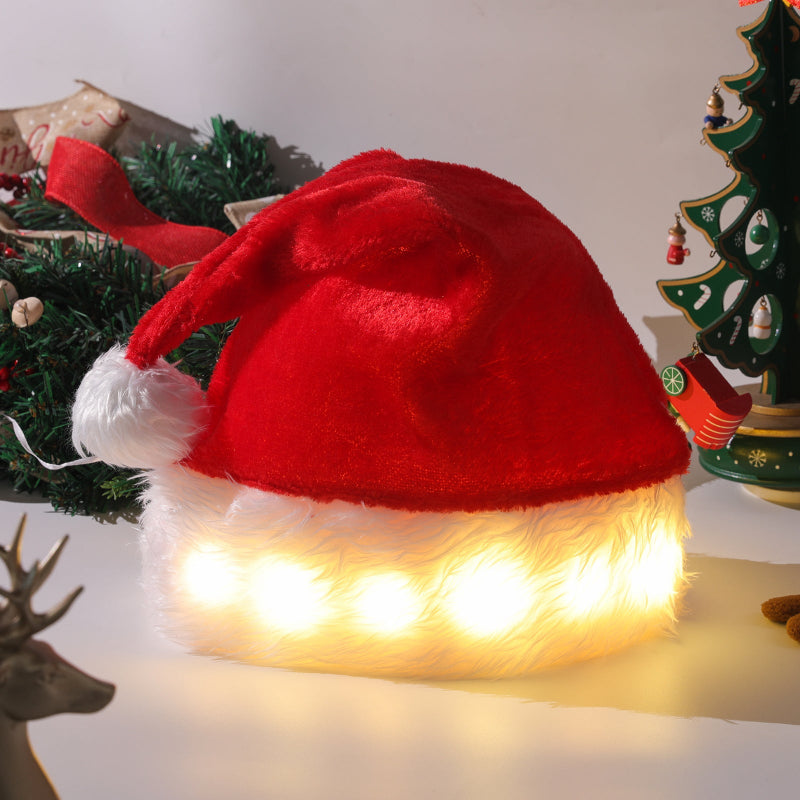 Red plush Christmas hat with white trim and warm LED light base glow
