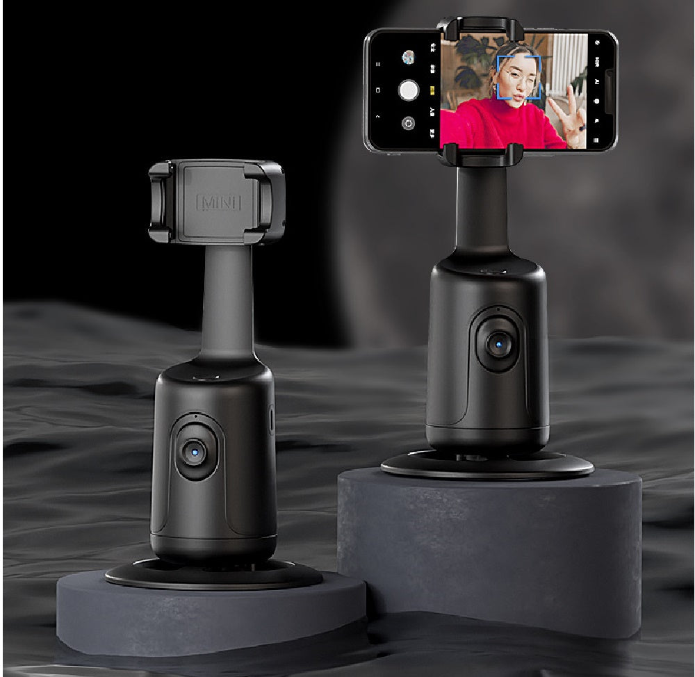 Black 360-degree phone holder stand with mounted clamp, angled view