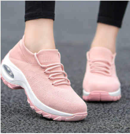 Pink knit lace-up athletic shoes with cushioned sole and oval air window detail