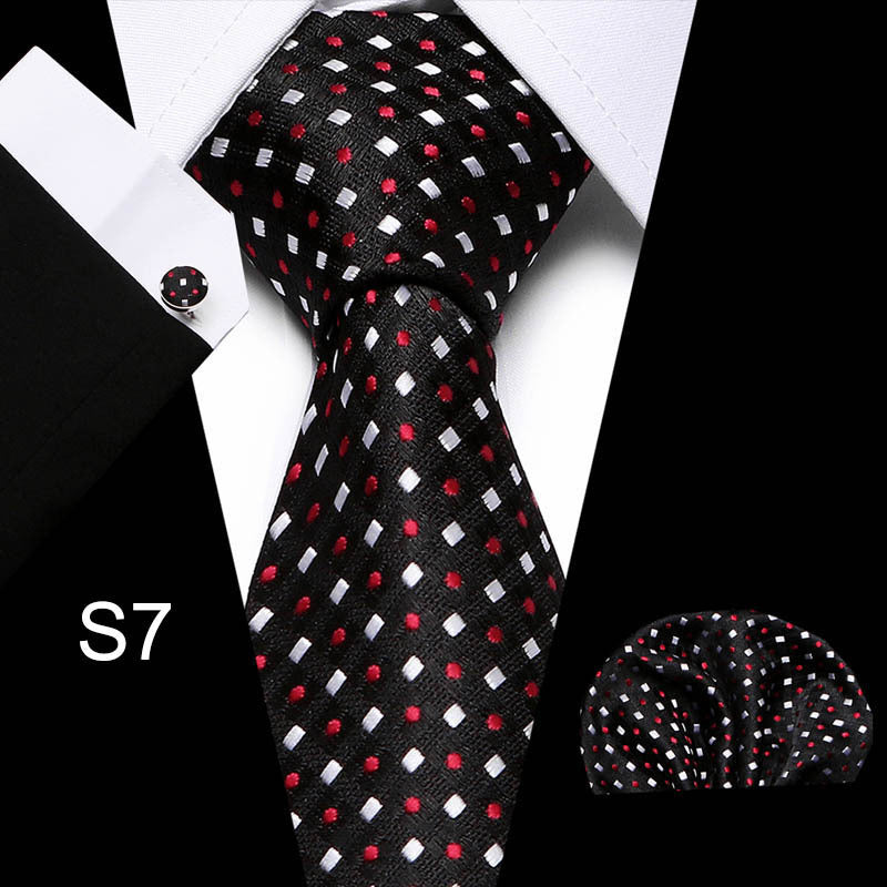 Men's business tie in black with scattered red and white dot and square pattern