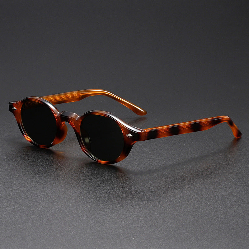 Men’s small round sunglasses with translucent tortoise-style frame and dark amber lenses