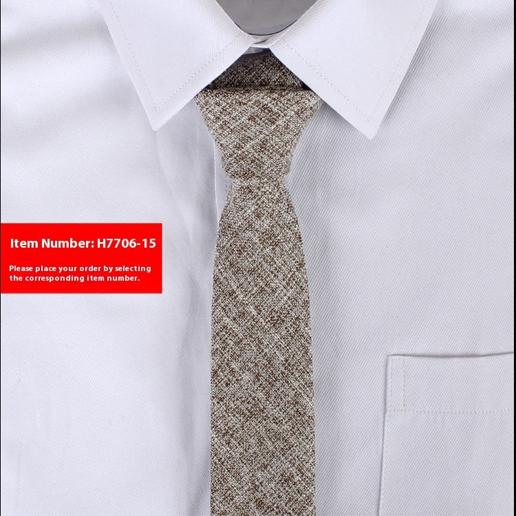 Narrow cotton tie in light brown tweed texture, tied in a slim knot.