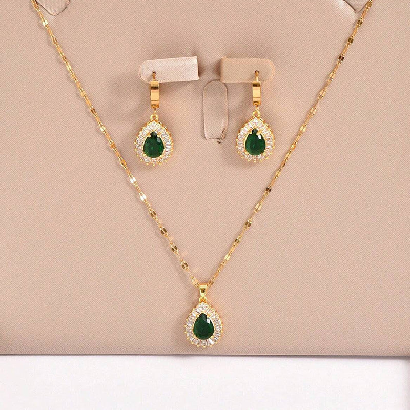 Gold-tone necklace and green teardrop stud earrings with crystal halo
