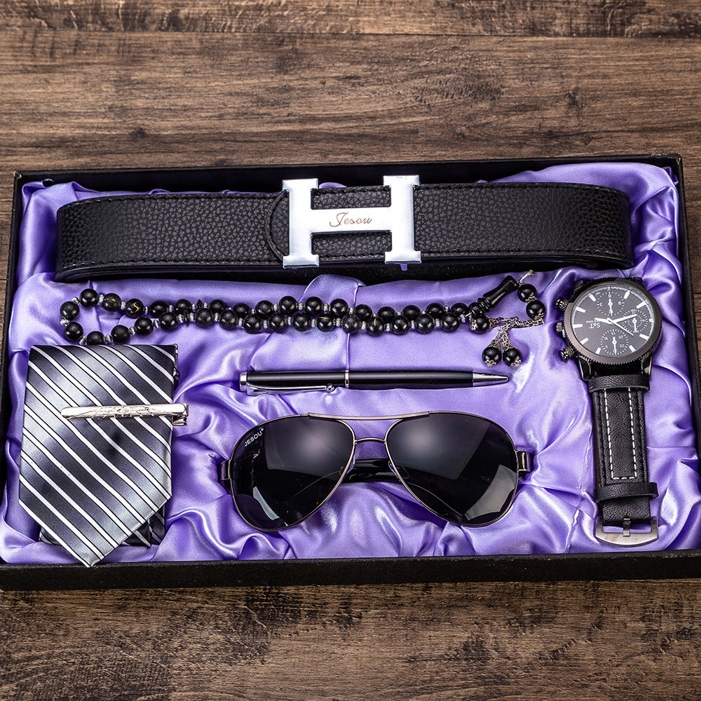 Men's gift set six-piece in open box: black belt, sunglasses, beaded necklace, tie, watch.