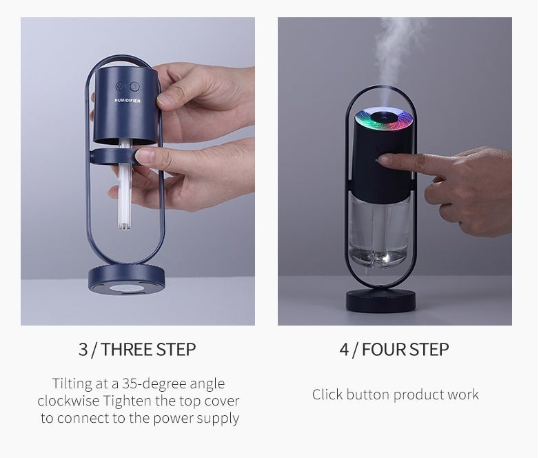 Hands adjusting and pressing a dark blue USB humidifier with clear base chamber