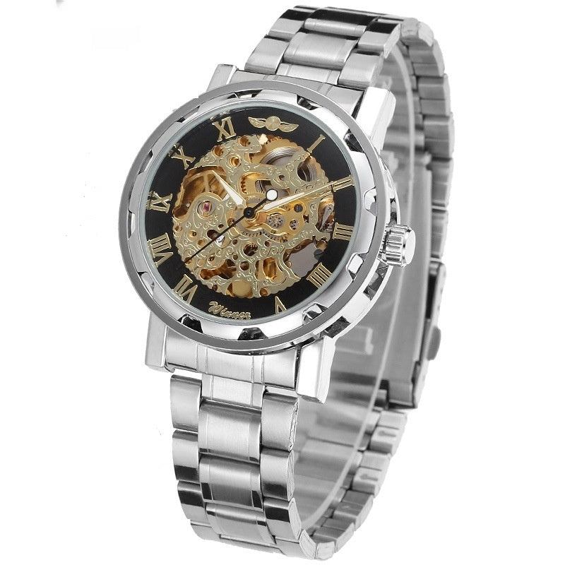 Mechanical skeleton watch with black dial, gold-toned gears, and silver metal bracelet