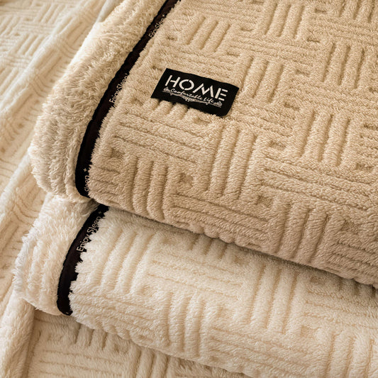 Beige textured blanket with a 'HOME' label on a matching fabric background