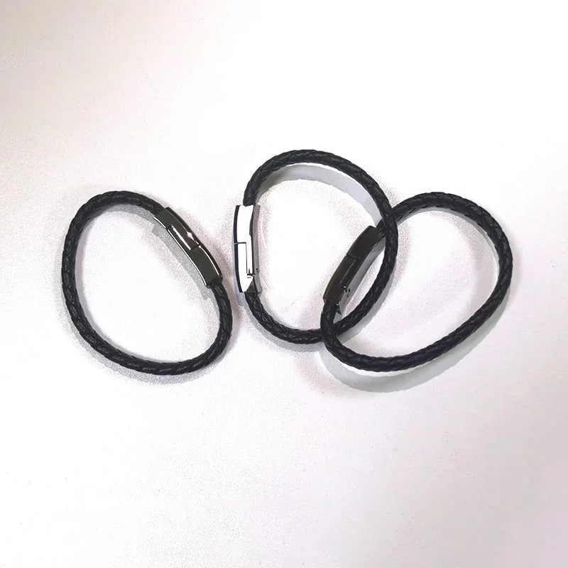 Black braided USB charging bracelet cable with open connector arms.