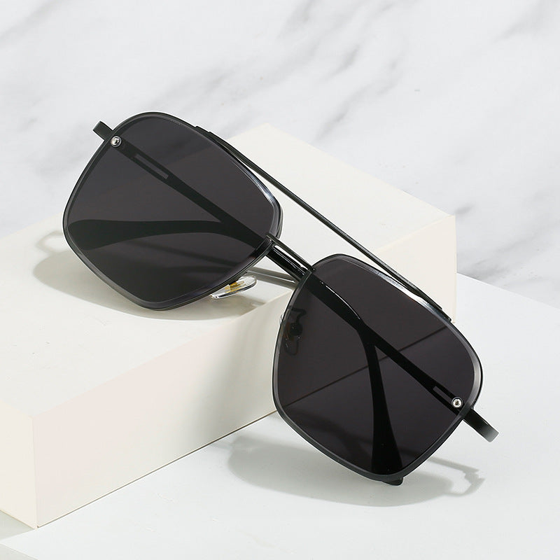 Men's sunglasses with double bridge metal frame and black lenses, close side view