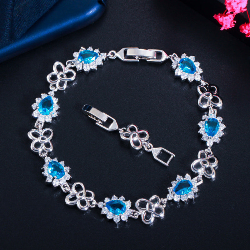 18K gold-plated zircon bracelet with blue gemstone links and heart motif accents